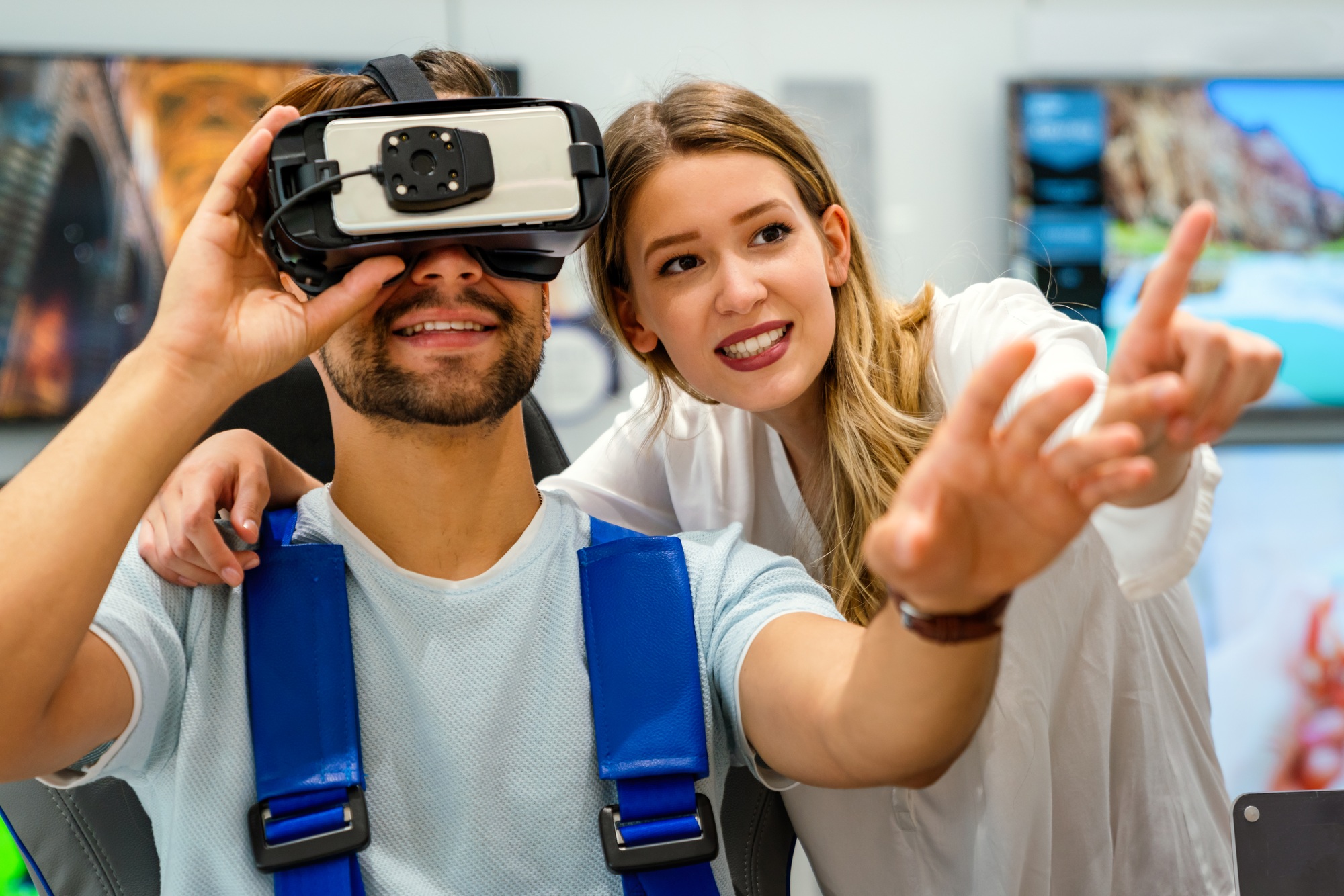 Young couple testing VR gear in-store, exploring interactive tech as part of clearance electronics Florida shoppers can’t miss.