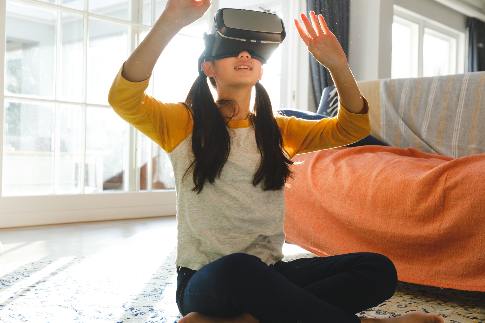 Young user immersed in virtual reality using a VR headset at home—dynamic visual for campaigns that encourage customers to Buy VR Headsets Online. 