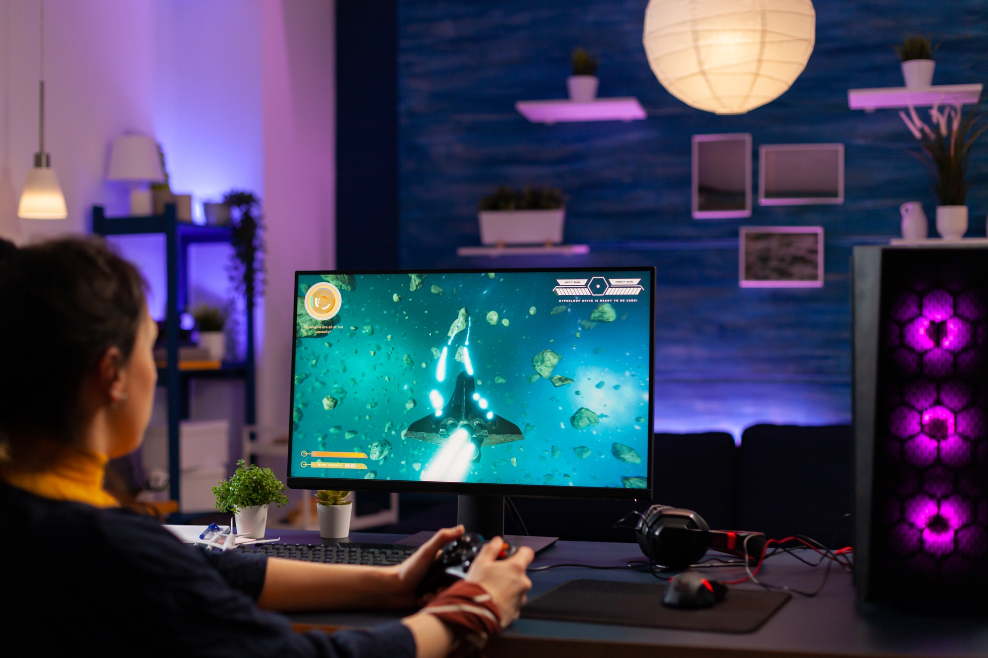 Gamer using high-performance setup with vibrant desktop tower and monitor in immersive environment—perfect visual for Gaming Desktops Florida promotion.

