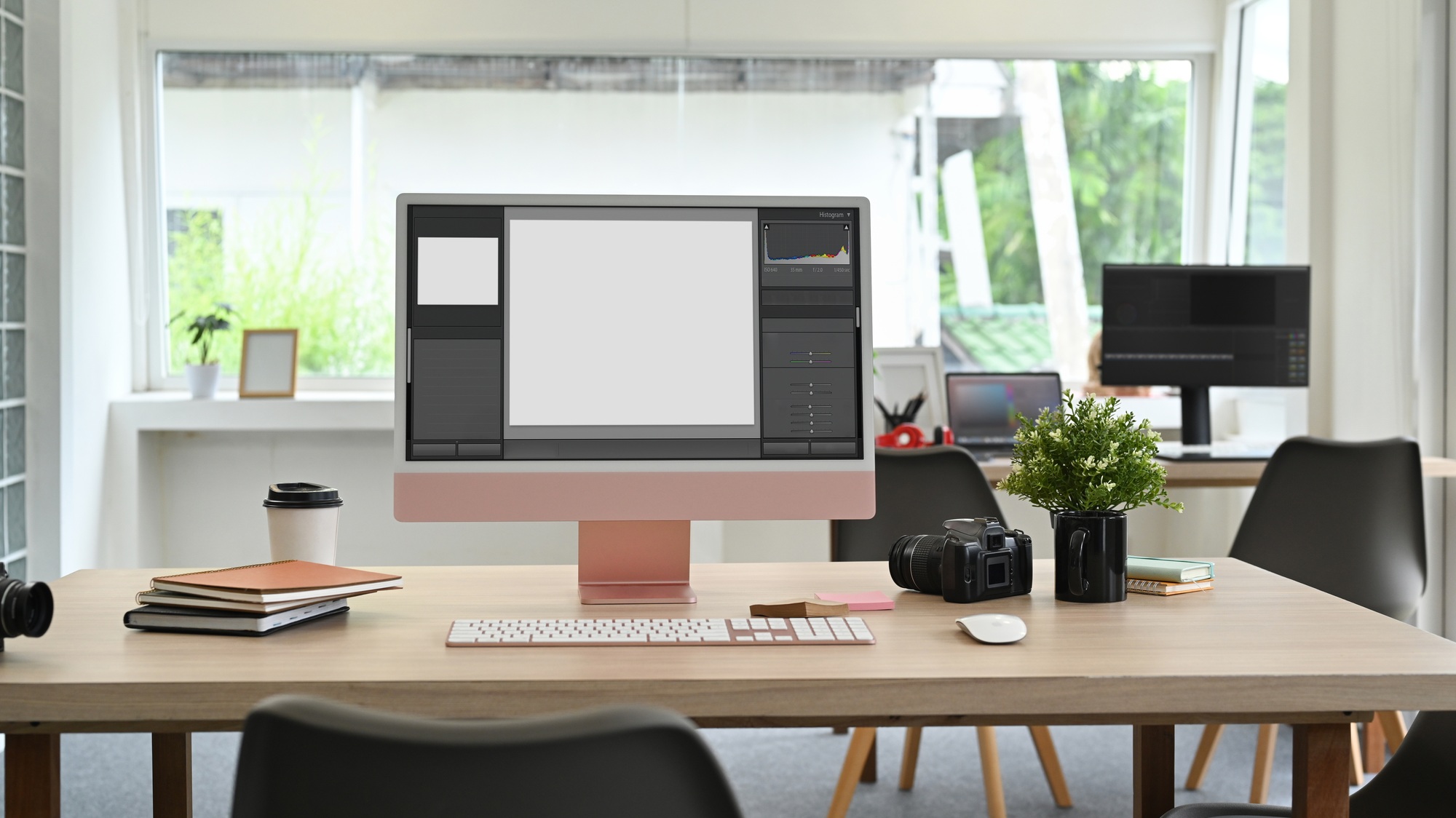A modern office setup featuring business workstation computers with large monitors, a wireless keyboard, and productivity tools on a wooden desk, ideal for corporate environments. 