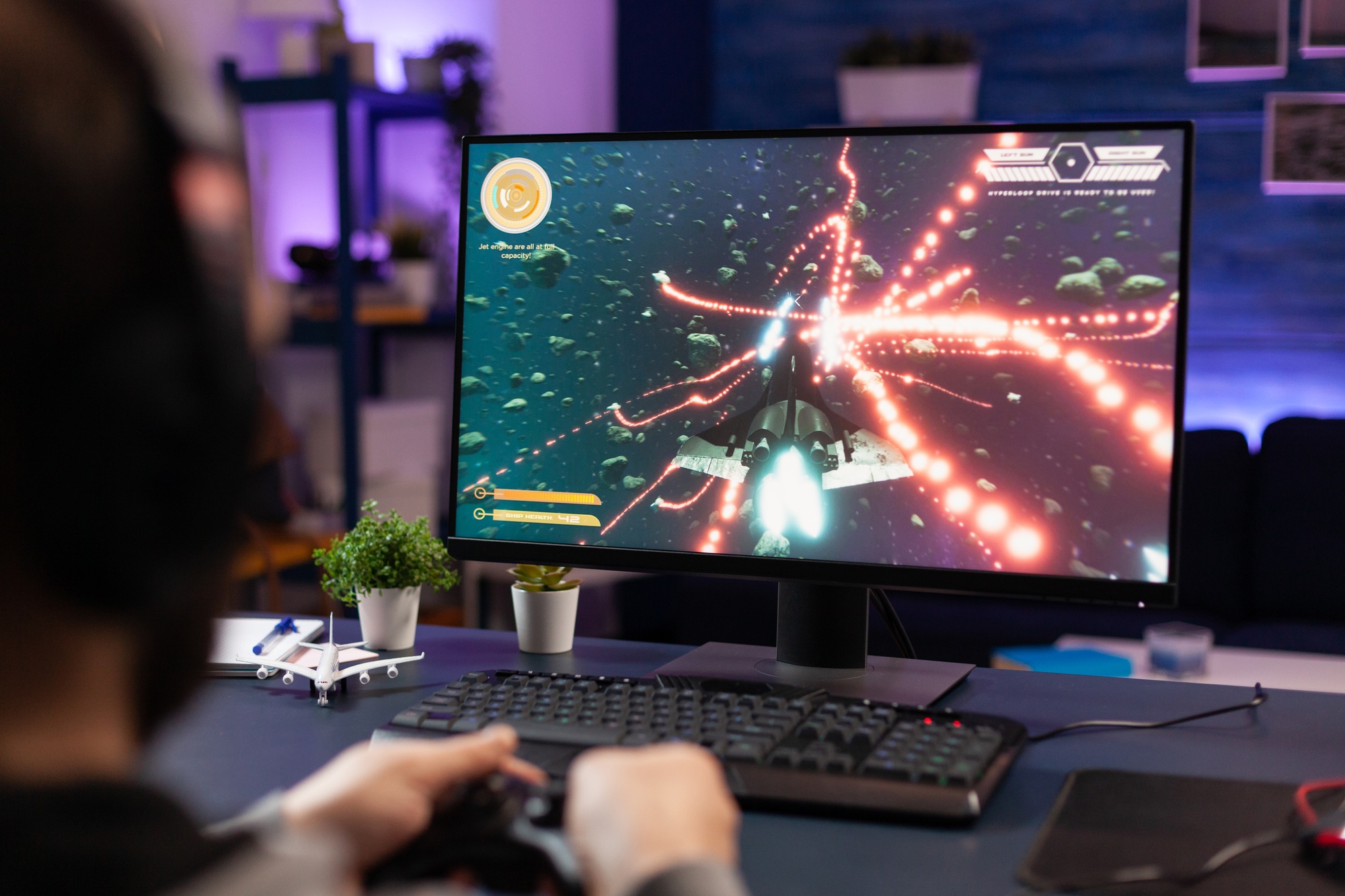 Gamer playing an action-packed space shooter on a high-performance desktop, showcasing powerful hardware built with top gaming processors for sale.