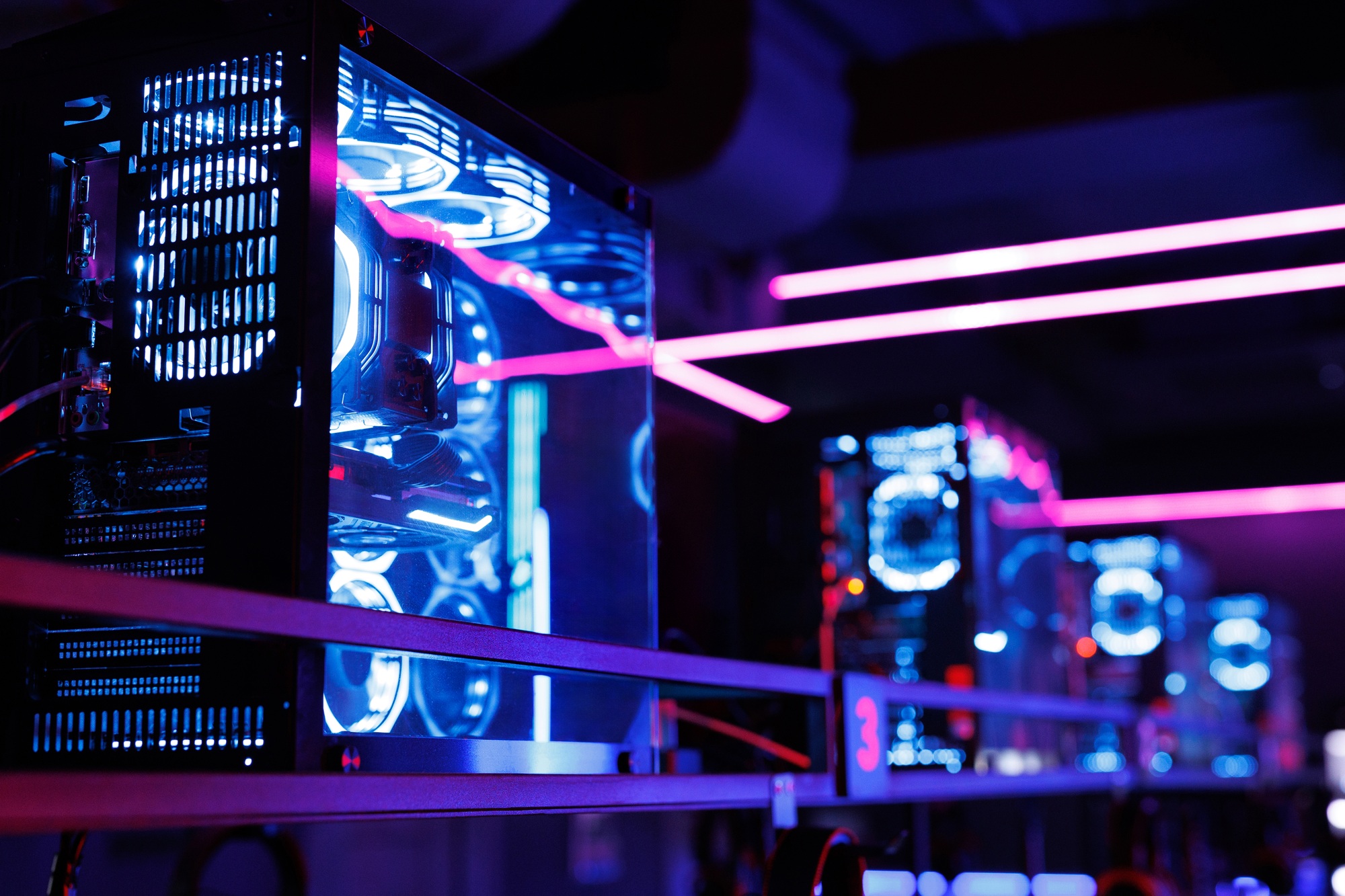 Rows of high-performance desktop PCs with illuminated cooling and transparent cases, ideal for users looking to buy SSD and HDD online for maximum speed and storage.