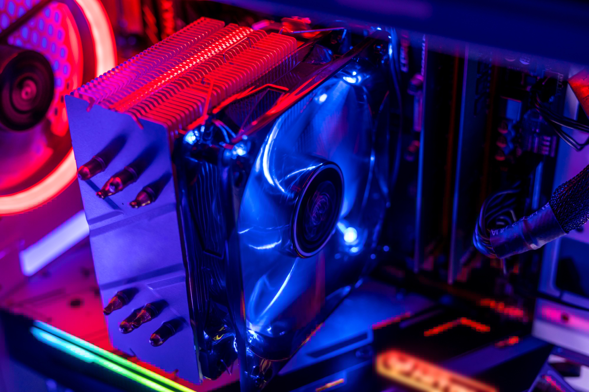 Close-up of a custom-built gaming PC with illuminated cooling fans and performance components, highlighting the need to buy RAM online for top-tier speed.