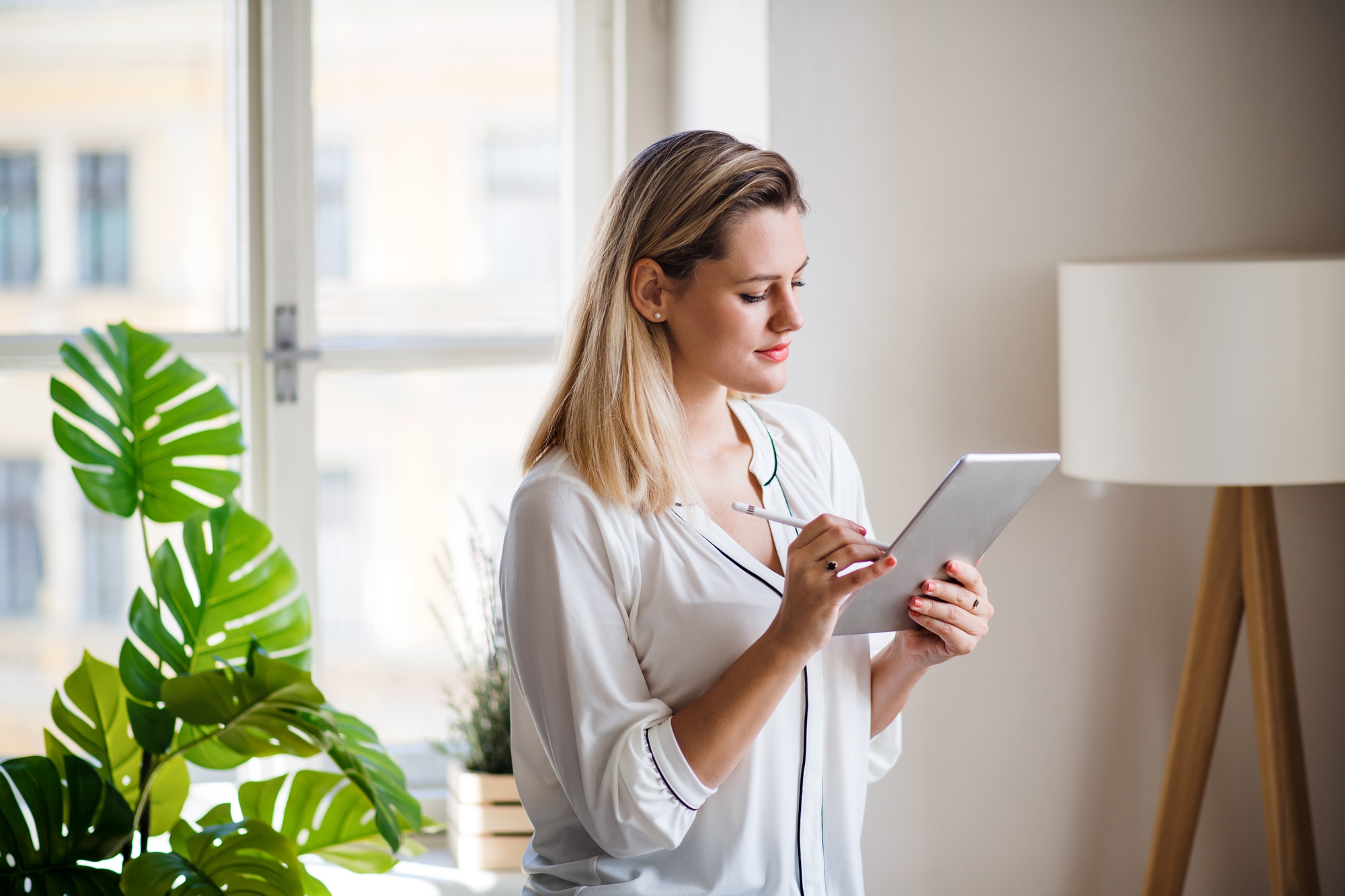 Professional woman using an Android tablet with stylus in a modern workspace—ideal visual for promoting deals to buy Android tablets for work and creativity. 